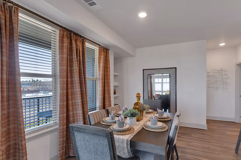 Dining area with modern furnishings at Alta Green Mountain Apartments, featuring stylish decor and ample natural light