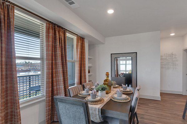 Dining area with modern furnishings at Alta Green Mountain Apartments, featuring stylish decor and ample natural light