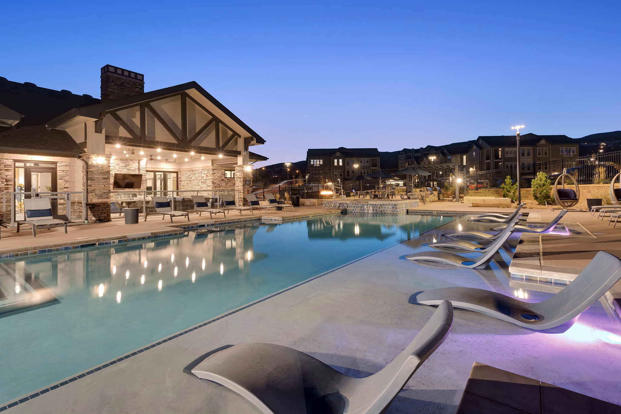 Luxurious pool area with mountain views at Alta Green Mountain Apartments