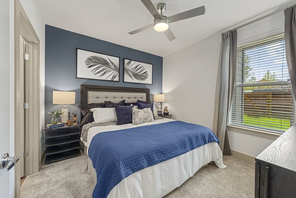 Elegant bedroom with modern furnishings at Alta Landing Apartments