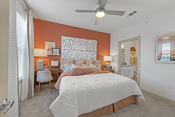 Cozy bedroom with modern decor at Alta Landing Apartments, featuring luxury finishes and a serene color palette