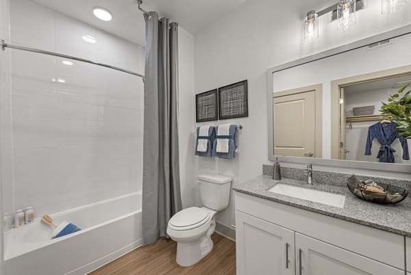 Luxurious bathroom with elegant marble countertops and modern fixtures at Alta Landing Apartments