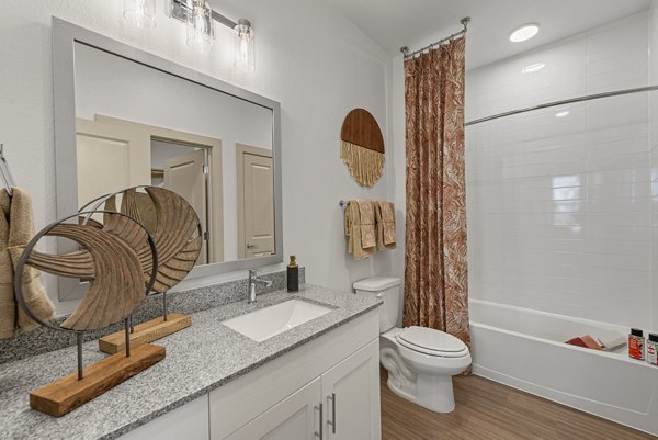 Modern bathroom with sleek fixtures and granite countertops at Alta Landing Apartments