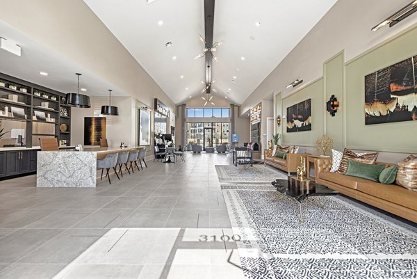 Modern clubhouse featuring stylish seating and billiard table at Alta Landing Apartments