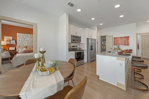 Dining room featuring elegant furnishings and modern lighting at Alta Landing Apartments
