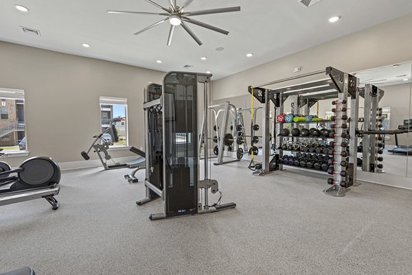 Fitness center with modern equipment at Alta Landing Apartments, offering residents a comprehensive workout experience in luxury surroundings