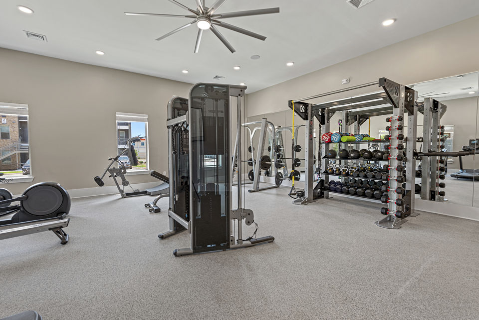 Fitness center with modern equipment at Alta Landing Apartments, offering residents a comprehensive workout experience in luxury surroundings