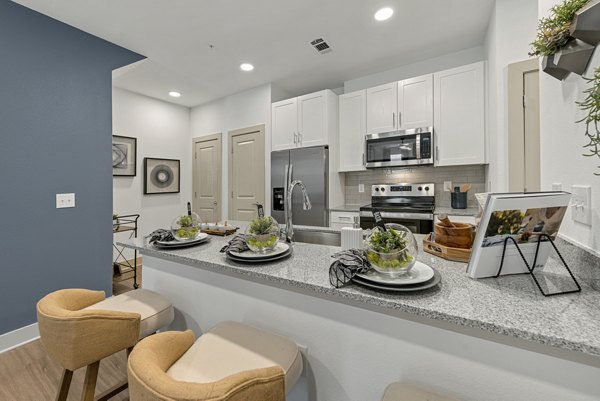 Modern kitchen featuring stainless steel appliances in Alta Landing Apartments