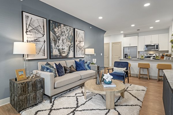 Cozy living room with modern decor at Alta Landing Apartments, featuring a comfortable seating area and stylish furniture setup