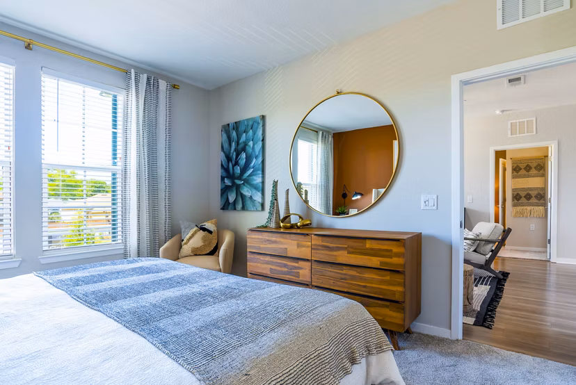 Spacious bedroom with modern furnishings at Alta Longwood Apartments â€“ luxury living in a serene setting