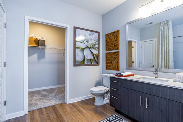 Modern bathroom with elegant vanity and glass shower in Alta Longwood Apartments luxury apartments
