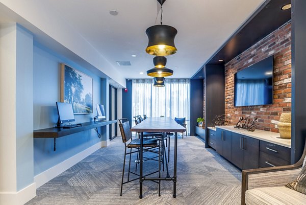 Clubhouse business center with modern workstations at Alta Longwood Apartments