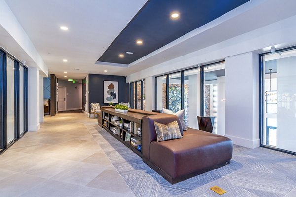Clubhouse lobby with modern decor and seating area at Alta Longwood Apartments, offering luxury living in a welcoming environment
