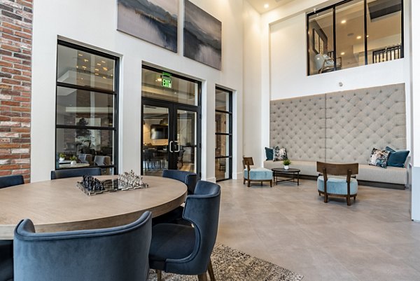 Clubhouse lounge with modern seating and decor at Alta Longwood Apartments