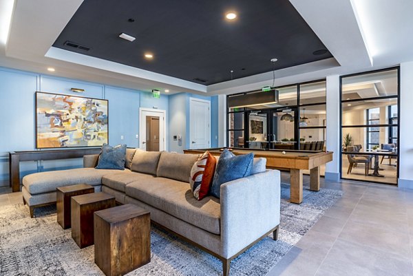 Clubhouse game room featuring pool table and lounge seating at Alta Longwood Apartments, perfect for socializing and relaxation