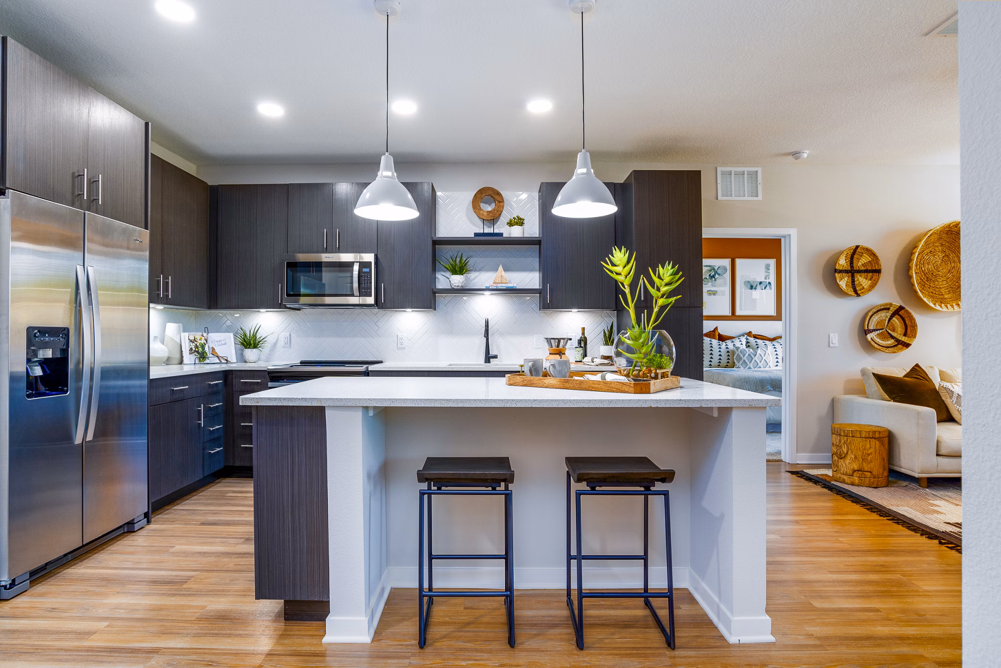 Contemporary kitchen with granite countertops and stainless steel appliances at Alta Longwood Apartments in sunny Florida