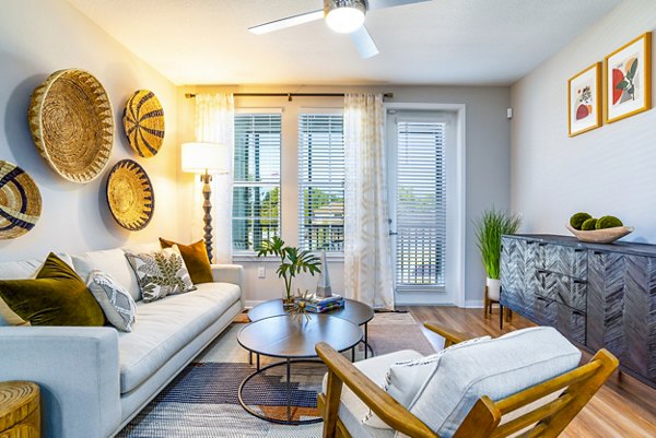 Spacious living room with modern furnishings in Alta Longwood Apartments