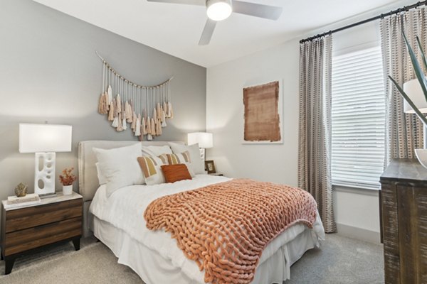 Modern bedroom with elegant decor at Alta Marine Creek Apartments, featuring a spacious layout and stylish furniture