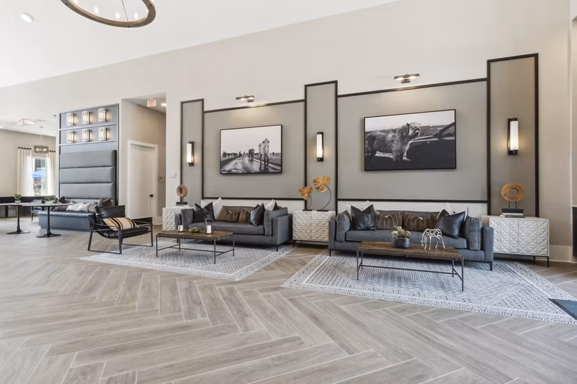 Clubhouse featuring modern design and ample seating at Alta Marine Creek Apartments, a luxury community offering premium amenities