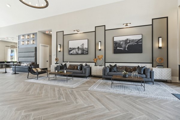 Clubhouse featuring modern design and ample seating at Alta Marine Creek Apartments, a luxury community offering premium amenities