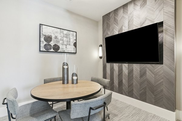 Meeting room with modern conference table and large windows at Alta Marine Creek Apartments