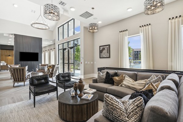 Clubhouse at Alta Marine Creek Apartments featuring modern design and seating areas