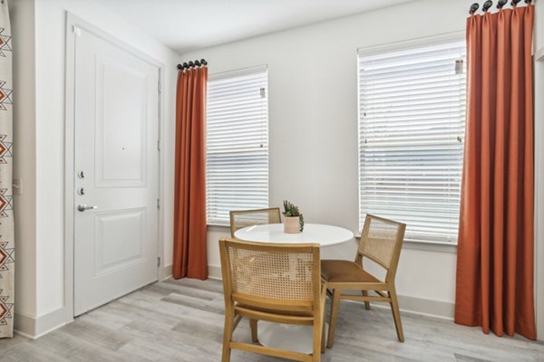 Dining room with modern furnishings and elegant lighting at Alta Marine Creek Apartments