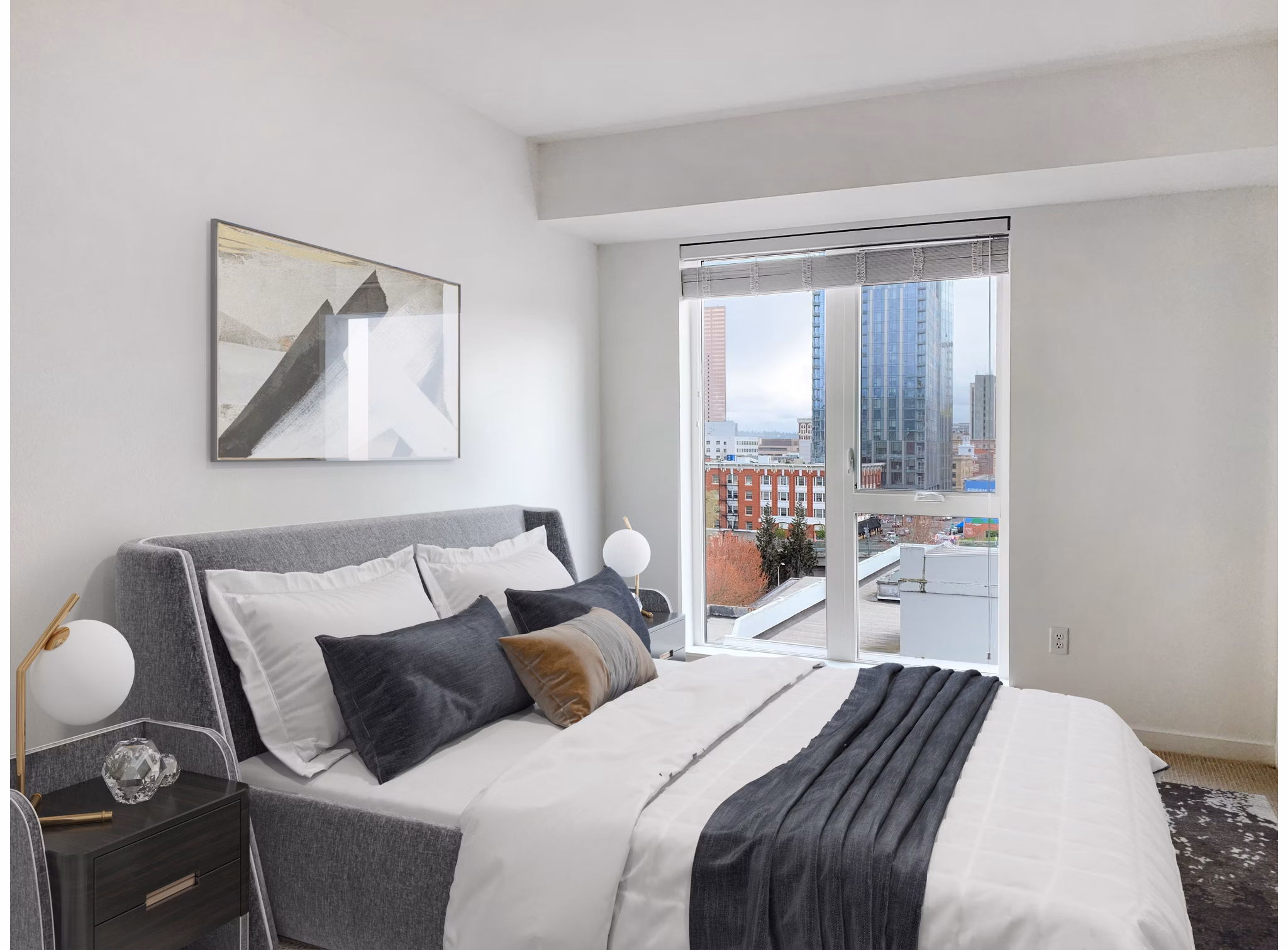Bedroom with modern furnishings at Alta Peak Apartments, a Greystar community, featuring large windows and stylish decor for luxury living
