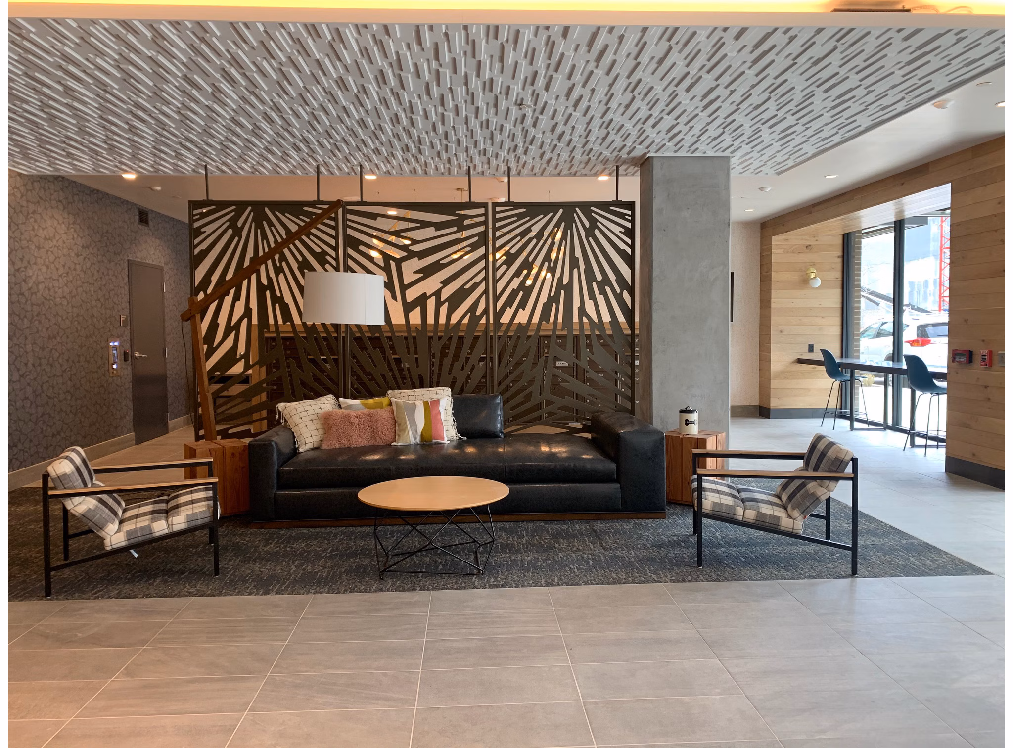Clubhouse with modern decor at Alta Peak Apartments featuring a lounge area and meeting spaces for residents