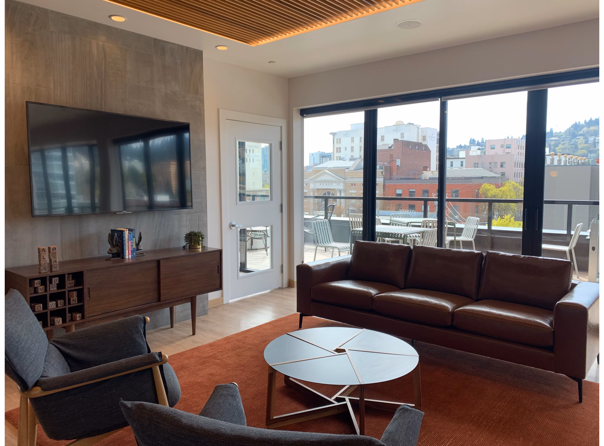 Clubhouse featuring modern design and lounge seating in Alta Peak Apartments