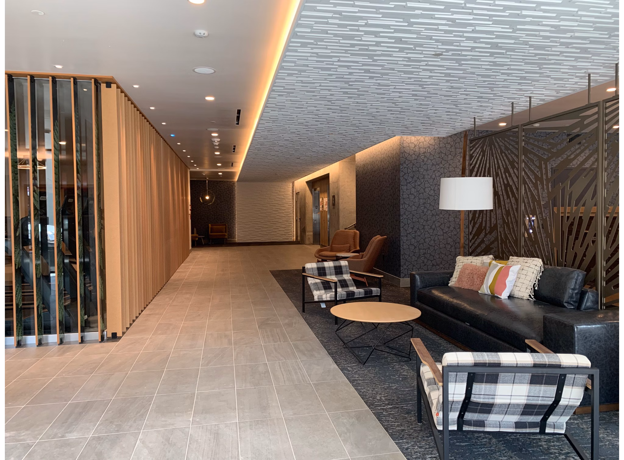 Clubhouse with modern decor and cozy seating at Alta Peak Apartments, a luxury living community