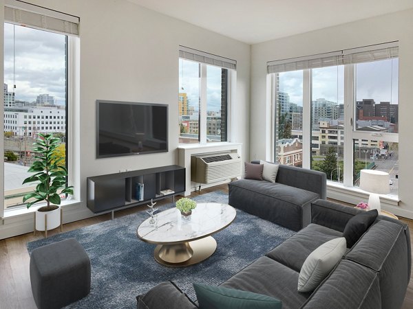 Living room with modern furnishings at Alta Peak Apartments, Greystar luxury community