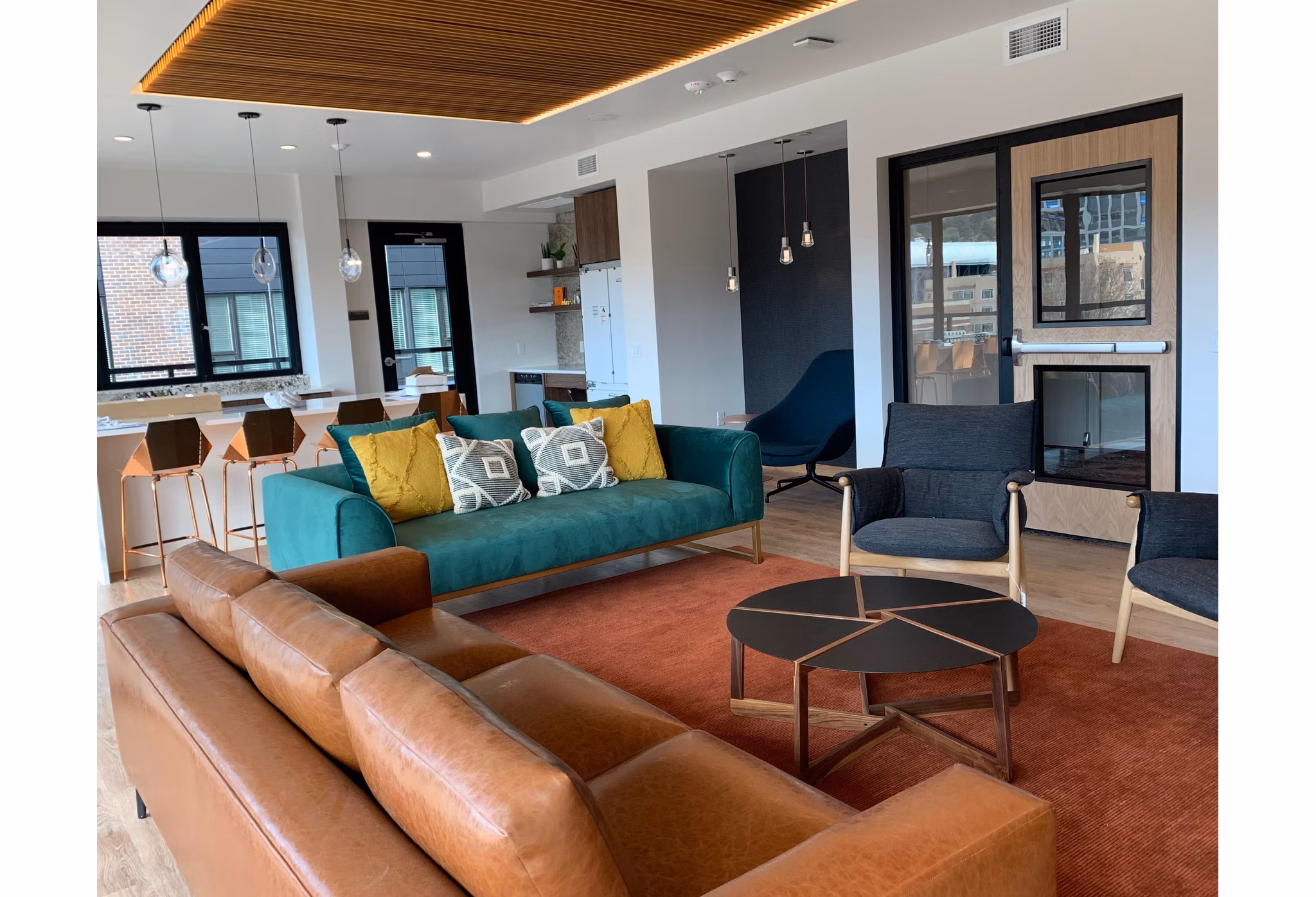 Modern rooftop lounge with mountain views at Alta Peak Apartments