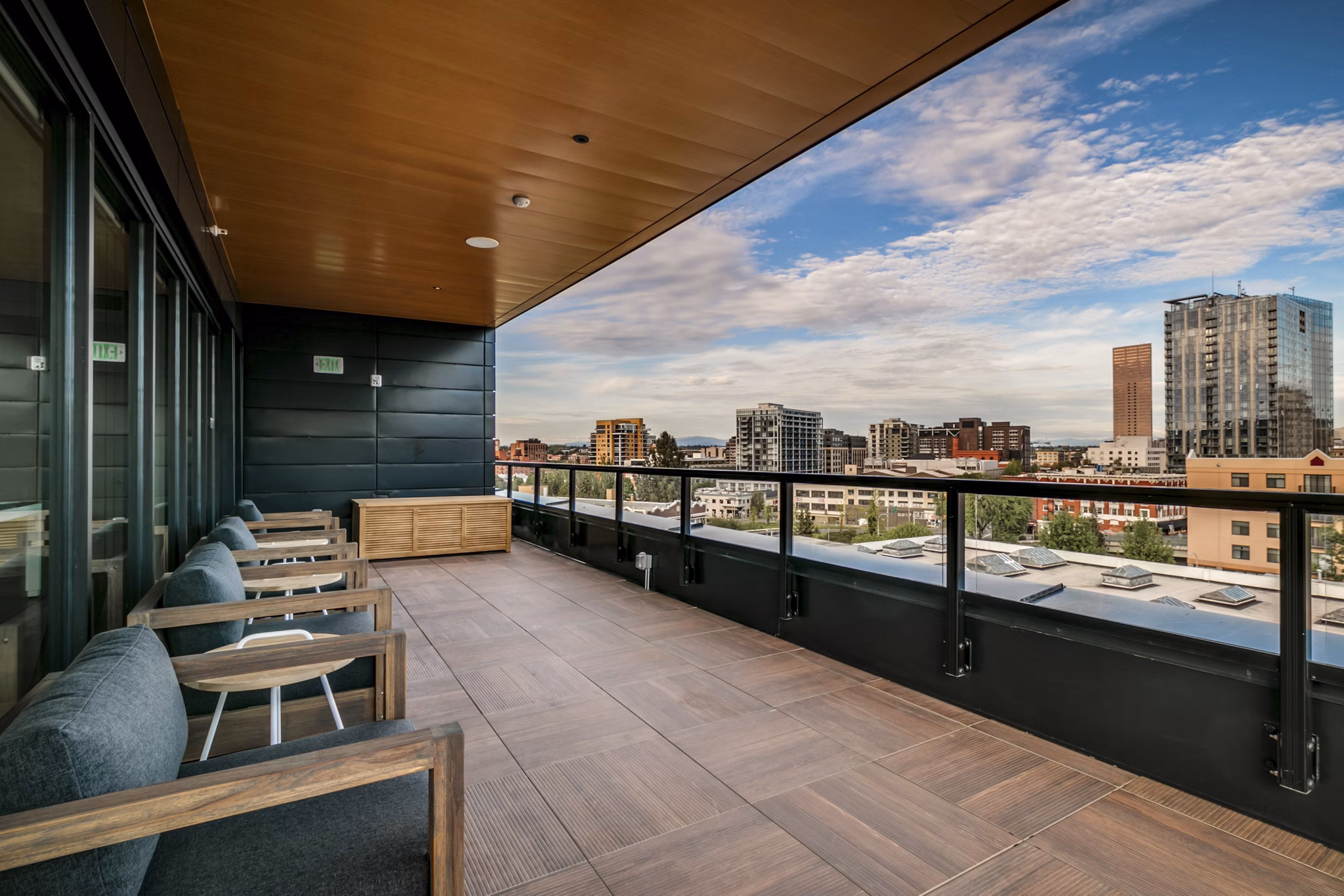 Patios with seating and lush greenery at Alta Peak Apartments, offering a serene outdoor living space in a Greystar luxury community