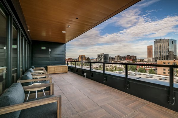 Patios with seating and lush greenery at Alta Peak Apartments, offering a serene outdoor living space in a Greystar luxury community