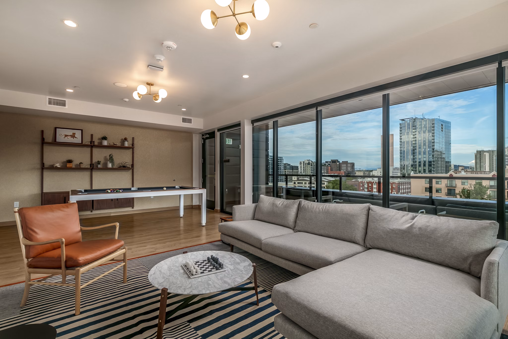 Recreation room featuring billiards and big-screen TV in Alta Peak Apartments luxury community