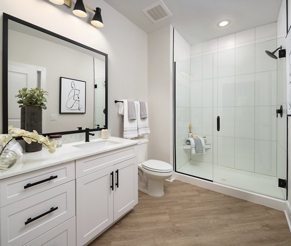 Modern bathroom with sleek fixtures and granite countertops at Alta Porter on Peachtree Apartments