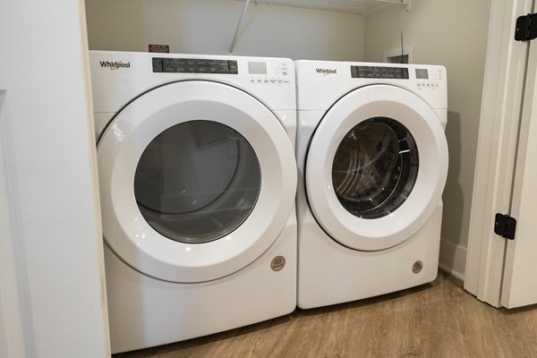 Laundry facility at Alta Porter on Peachtree Apartments featuring modern machines in a convenient setup for residents' ease and efficiency