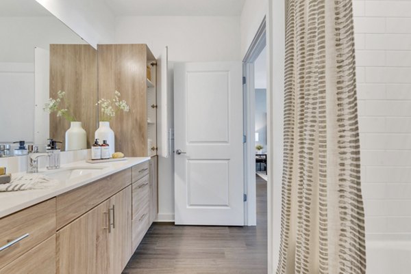 Modern bathroom with sleek fixtures and tiled flooring at Alta Purl Apartments