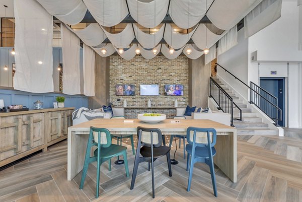 Clubhouse at Alta Purl Apartments: Modern design with cozy seating areas and vibrant decor