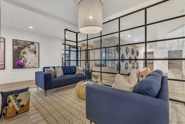 Clubhouse boasting stylish seating and modern decor at Alta Purl Apartments, a Greystar luxury community