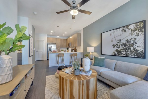 Spacious living room with modern furnishings at Alta Purl Apartments