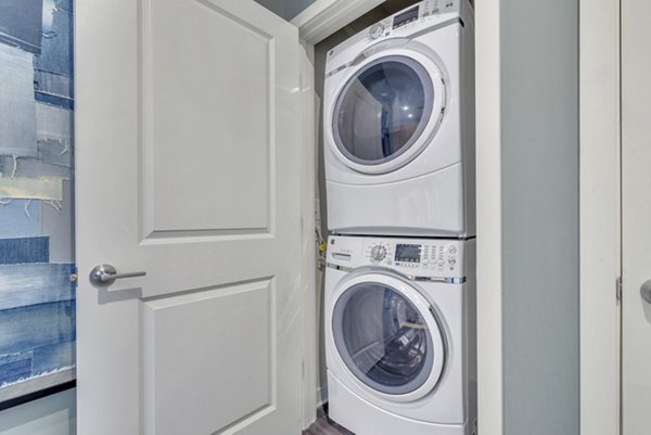 Alta Purl Apartments: Modern laundry room featuring high-efficiency washers and dryers