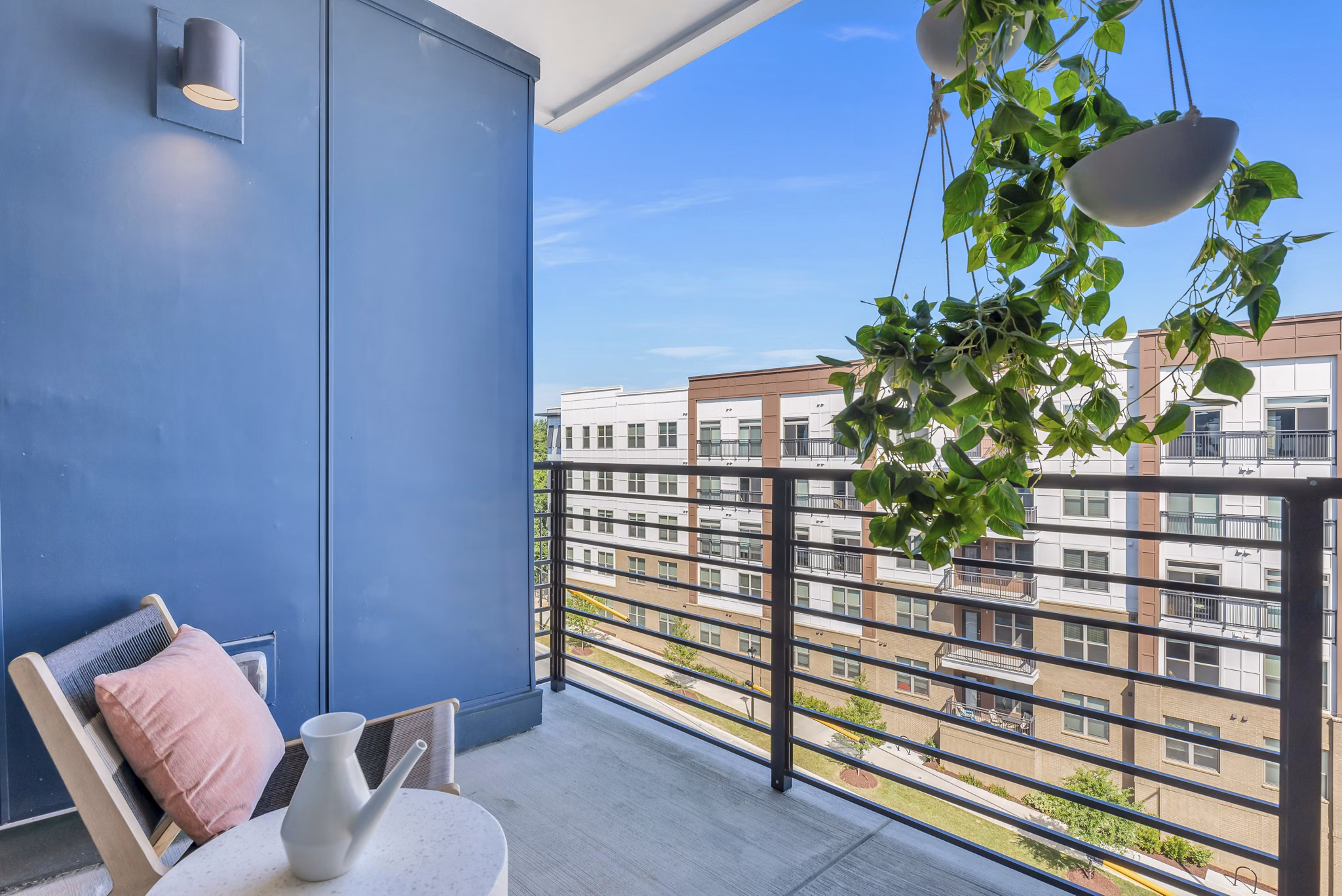 Outdoor patio with stylish seating and lush landscaping at Alta Purl Apartments