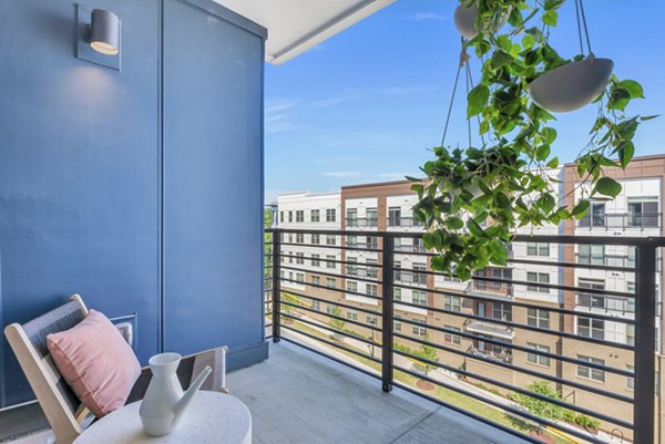 Outdoor patio with stylish seating and lush landscaping at Alta Purl Apartments