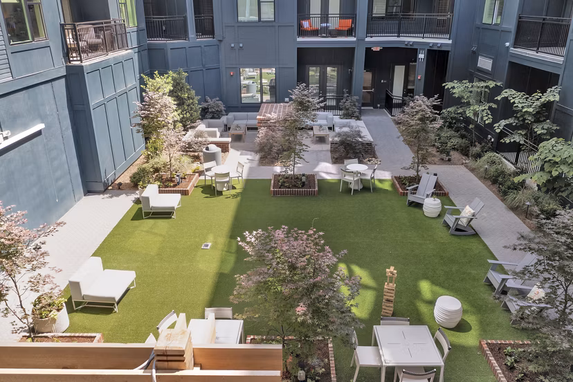Courtyard with lush greenery at Alta Purl Apartments providing a serene outdoor space for residents