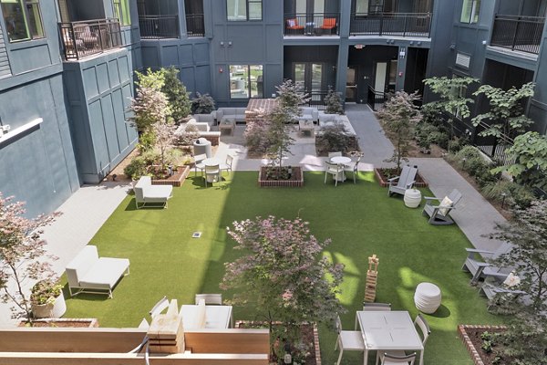 Courtyard with lush greenery at Alta Purl Apartments providing a serene outdoor space for residents