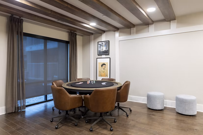 Modern social lounge and clubhouse with elegant seating and game tables at Alta River Oaks Apartments, Houston