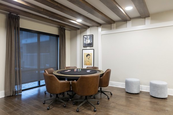 Modern social lounge and clubhouse with elegant seating and game tables at Alta River Oaks Apartments, Houston