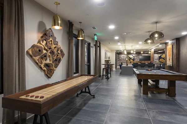 Clubhouse with modern design elements at Alta River Oaks Apartments, featuring lounge seating and open spaces for relaxation and socializing